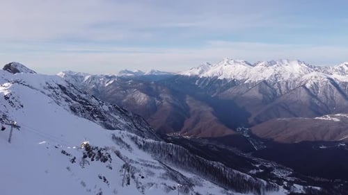 Aerial View of Snow Mountain Range Landscape in Sochi Under Blue Sky