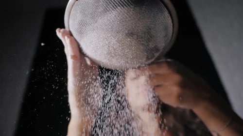 Woman Sifting Flour in Kitchen, Close-Up