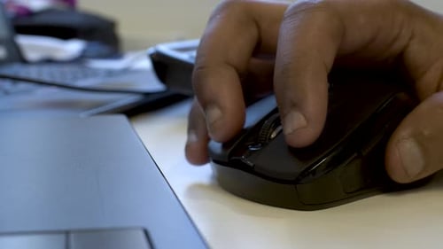 Close Up Of Ethnic Minority Male Hand Using Computer Mouse. Locked Off