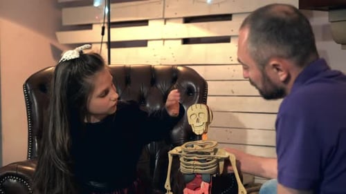Inquisitive Daughter Asking Her Father Many Questions About Human Body Structure