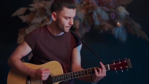 Man Playing Acoustic Guitar and Singing