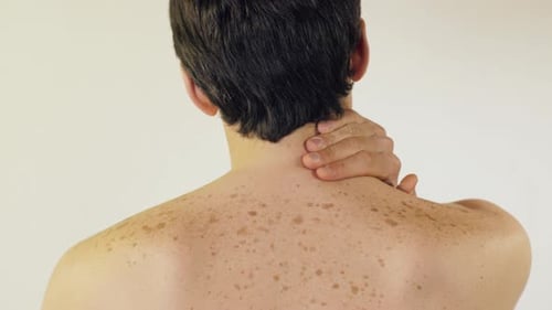 Adult Man Massages Neck Due to Pain