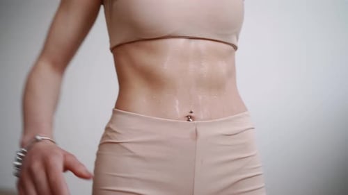 Sweaty Woman Showing Her Abs After Exercise