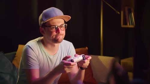 Young Man Playing Video Games at Home at Night