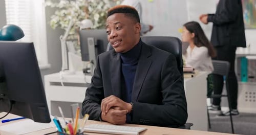 Office Worker Sits in Front of Computer at Desk Has Video Call Internet Connection Through Webcam