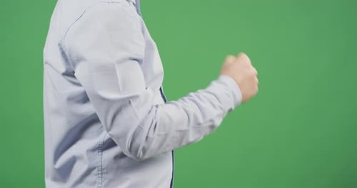 Side view of a man's fist clenching