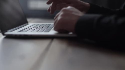 Closeup Tracking Shot of Unrecognizable Mature Adult Man Writing Text on Portable Wireless Computer