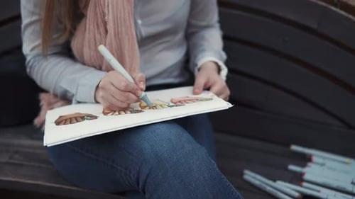 Sketching on the Bench Outside.