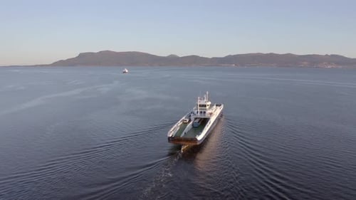 Norwegian Ferry Service Crossing a Fjord Carrying Passengers and Vehicles