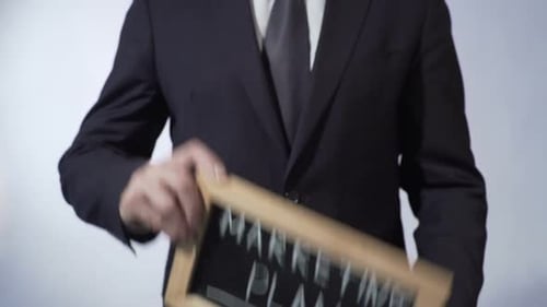 Man Holds Marketing Plan Chalkboard
