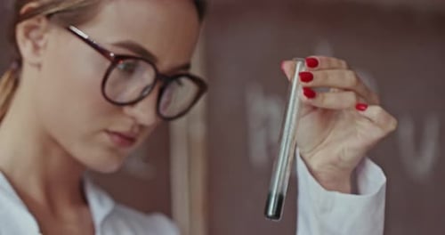 Young Female Scientist or Chemist Working in a Lab