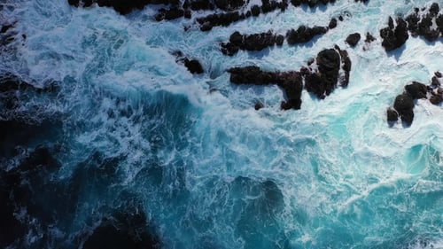 Waves of the Atlantic Ocean crash on coastal rocks