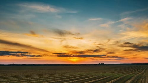 Aerial View Of Sunset Bright Sky Above Summer Hay Field Landscape In Evening