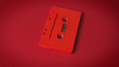 Old Red Cassette Tape on a Minimalist Background