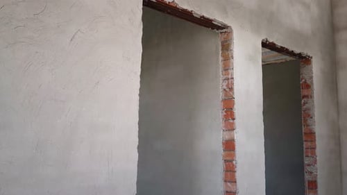 Unfinished Plastered Walls and Brick Doorways in New Home