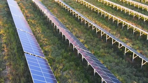 Drone flying over exspanse of solar panels in the field. renewable energy,Italy