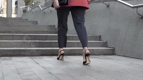 Close Up, the Girl in High Heels Goes Up the Stairs