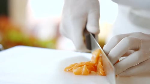 Knife Quickly Cuts Raw Fish.