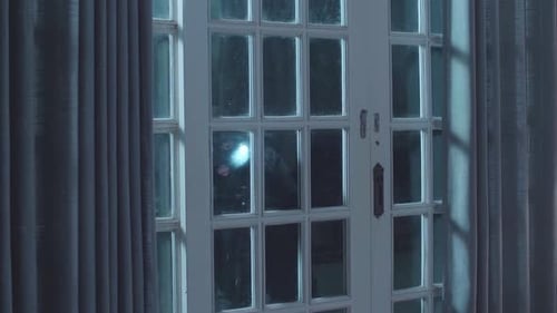 Person with Flashlight Trying to Break Into Home