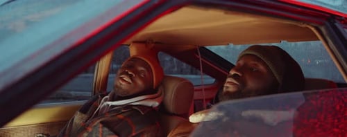 Two Black Men Sitting in Car and Talking in Evening