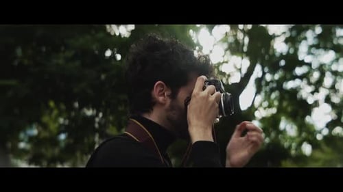 Young Man Taking a Photograph in Natural Setting