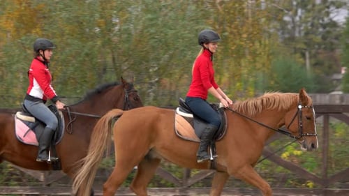Women Riding Horses in Rural Training Pen