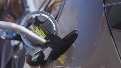 Man Opening Fuel Tank and Inserting Nozzle