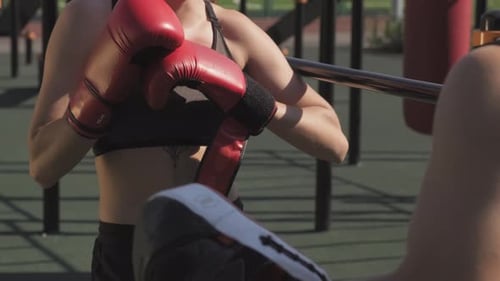 Smiling Woman Prepares for Boxing Training Outdoors