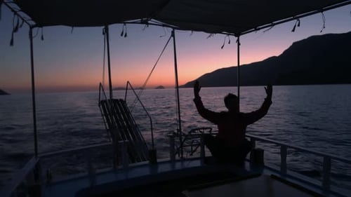 Meditative Silhouette on Boat at Twilight