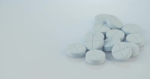 Pills on White Surface Close Up