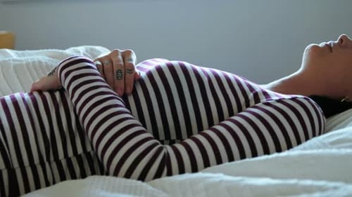 Woman Resting in Bed during Daytime