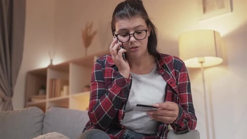 Woman on Phone with Credit Card