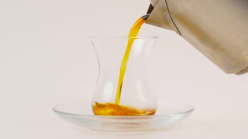 Tee in die Tasse geben.