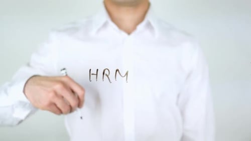 Man Writes HRM On Clear Surface