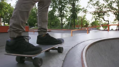 Skateboarder Riding in a Concrete Skate Park Slow Motion Close Up