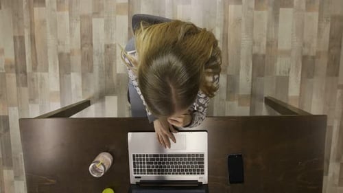 Top View of Female Drinking Smoothie at Workplace