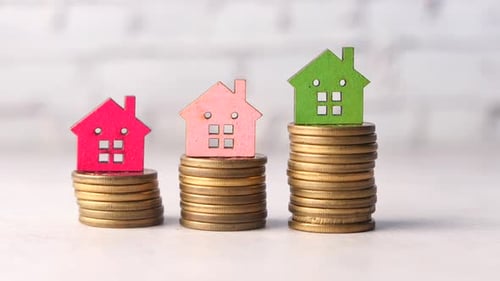 the Concept of Finance Concept with Stack of Coins and House on Table