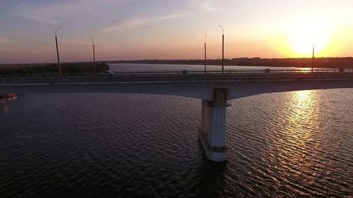 Aerial Shot of a Lofty Bridge at Golden Sunset From a Drone Moving Along in Summer