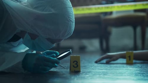 Investigator Examining Evidence with Tweezers and Magnifying Glass