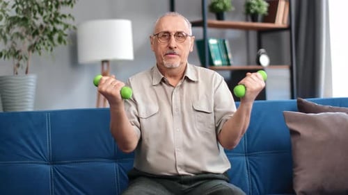 Senior Man Lifts Weights at Home