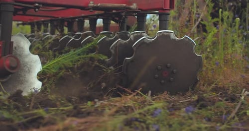 Tilling Implement in a Rural Grassy Field