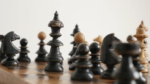 Close-up of detailed chess set figures 4K 2160p 30fps UltraHD footage - Old wooden king chessman on