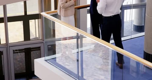 Businesspeople Chatting During Break Time in Office Lobby