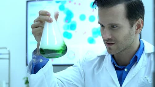 Scientist Examining Green Liquid in Beaker