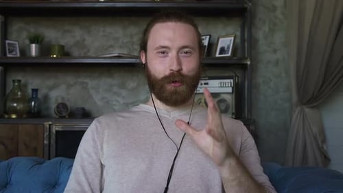 Bearded Man Speaking on Video Call Indoors