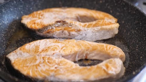 Red Fish in a Frying Pan Cook Sprinkles Salt Salmon Fish