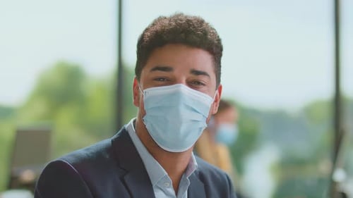 Young Adult Wearing Face Mask in Modern Office