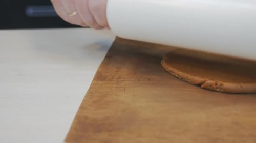 Cookie Dough Being Flattened and Shaped on Counter
