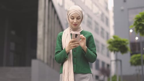 Woman Using Phone in Urban Setting