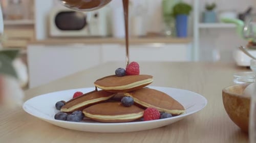 Stack of Pancakes with Chocolate and Berries